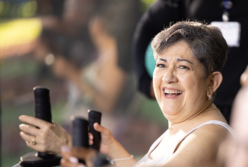 woman smiling using seated bike